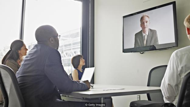 Coworkers in conference room participating in video conference call