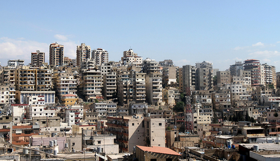 A general view shows the neighbourhoods of Bab al-Tabbaneh, a Sunni Muslim district, in the foreground and Jabal Mohsen, a mainly Alawite neighbourhood, in the background of the Lebanese northern port city of Tripoli on August 23, 2012. Fresh fighting erupted in Bab al-Tabbaneh leaving one dead and two wounded, a security source said, despite a truce to halt days of violence between pro- and anti-Damascus gunmen. AFP PHOTO / ANWAR AMRO (Photo credit should read ANWAR AMRO/AFP/GettyImages)