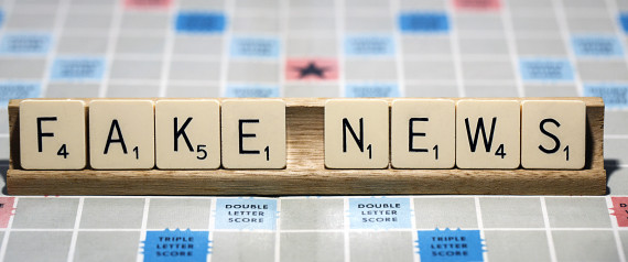 London, UK: January 31, 2017: A Scrabble game board with the letters forming the words 'Fake News'. Scrabble is a fun and educational game distributed worldwide by Hasbro.