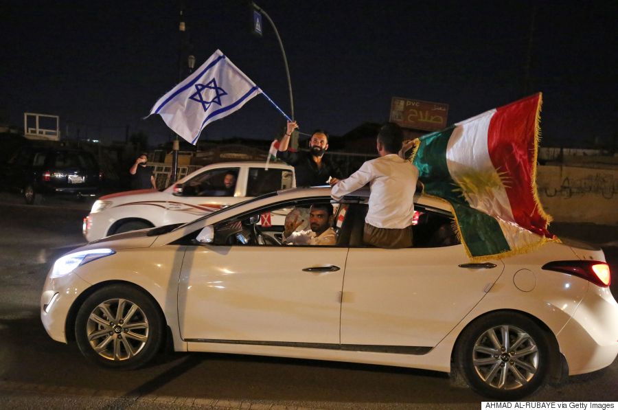 Iraqis Kurds carry the Kurdish and the Israeli flags in the streets of the northern city of Kirkuk on September 25, 2017 following a referendum on the independence.  Iraq's Kurds defied widespread opposition to vote in a historic independence referendum, sparking fresh tensions with Baghdad, threats from Turkey and fears of unrest. The vote in the autonomous Kurdish region of northern Iraq and some disputed areas is non-binding and will not lead automatically to independence, but is seen by the Kurds as a major step towards a long-cherished dream of statehood  / AFP PHOTO / AHMAD AL-RUBAYE        (Photo credit should read AHMAD AL-RUBAYE/AFP/Getty Images)