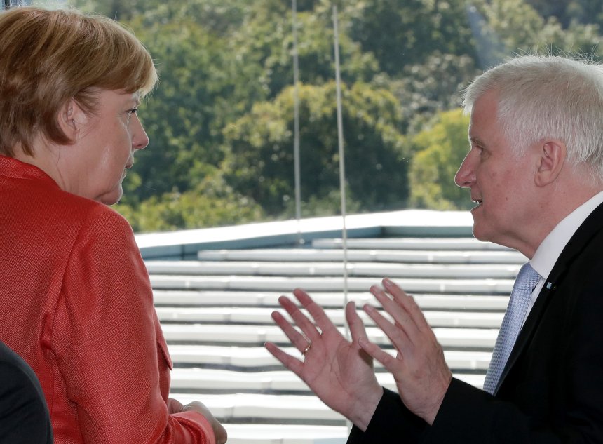 German Chancellor Angela Merkel, left, talks to the Governor of the German state of Bavaria, Horst Seehofer, right, prior to a meeting of the German government and mayors of various German cities in Berlin, Germany, Monday, Sept. 4, 2017 on air quality protection. (AP Photo/Michael Sohn)