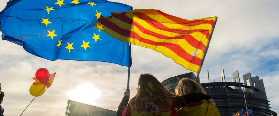 Women hold a Catalan and a European flag during a demonstration against Catalonia's independence in front of the European Parliament building in Strasbourg, eastern France, on October 24, 2017. Catalan separatists prepare to announce plans on October 24 for a campaign of "civil disobedience" in defiance of Madrid's threat to take control of the region as its leaders threaten to declare independence. / AFP PHOTO / PATRICK HERTZOG        (Photo credit should read PATRICK HERTZOG/AFP/Getty Images)