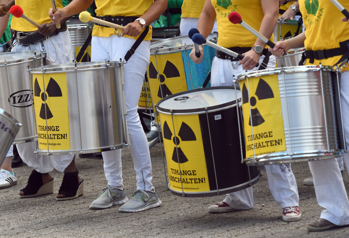 CORRECTION - Participants of the anti-nuclear "Chain Reaction" demonstration beat the drums to protest against the operation of Belgium's Tihange 2 and the Netherland's Doel 3 nuclear power plants on June 25, 2017 in Aachen, western Germany, close to the border with Belgium and the Netherlands. / AFP PHOTO / dpa / Henning Kaiser / Germany OUT / The erroneous mention appearing in the metadata of this photo by Henning Kaiser has been modified in AFP systems in the following manner: [Tihange] instead of [Thihange]. Please immediately remove the erroneous mentios from all your online services and delete it from your servers. If you have been authorized by AFP to distribute it to third parties, please ensure that the same actions are carried out by them. Failure to promptly comply with these instructions will entail liability on your part for any continued or post notification usage. Therefore we thank you very much for all your attention and prompt action. We are sorry for the inconvenience this notification may cause and remain at your disposal for any further information you may require. (Photo credit should read HENNING KAISER/AFP/Getty Images)