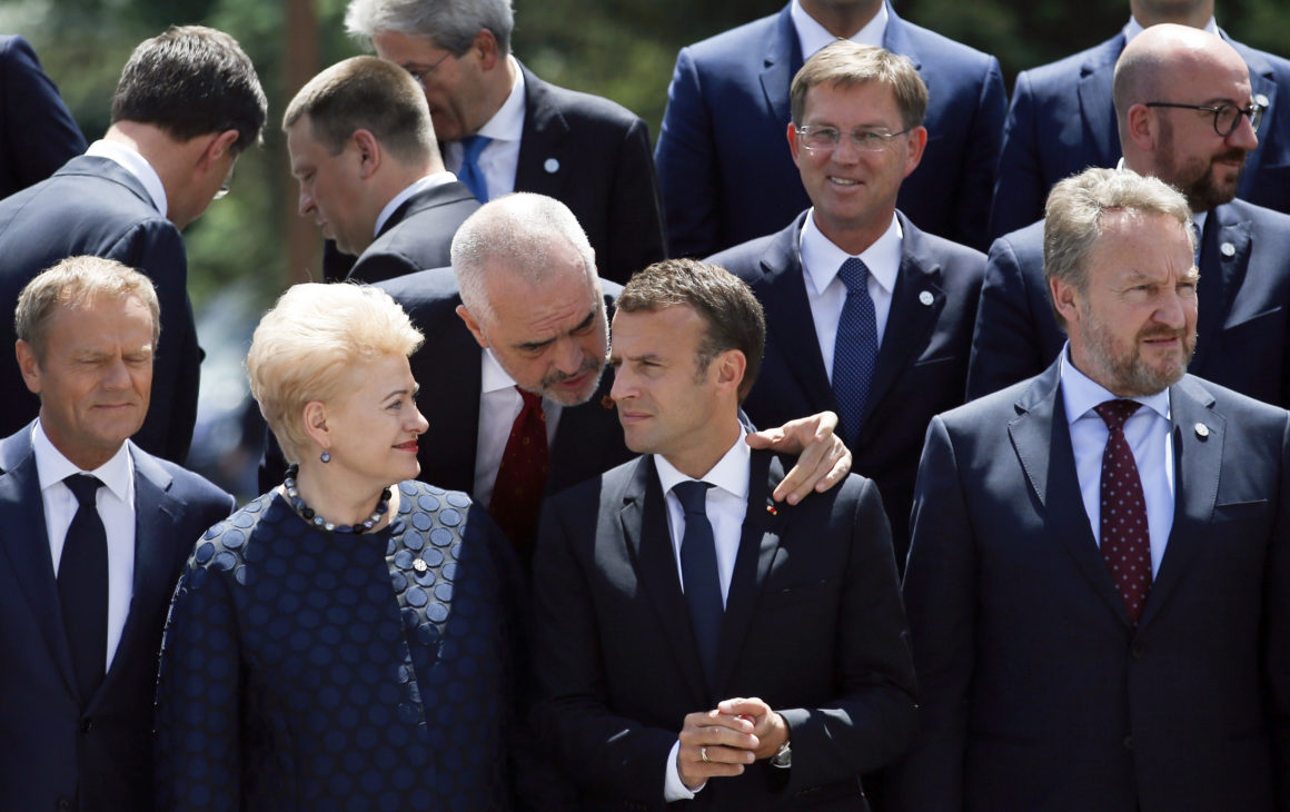Albania's Prime Minister Edi Rama (C) speaks with France's President Emmanuel Macron (2ndR) and Lithuania's President Dalia Grybauskaite (2ndL) as they pose for a family photo during an EU-Western Balkans Summit in Sofia on May 17, 2018. - European Union leaders meet their Balkan counterparts to hold out the promise of closer links to counter Russian influence, while steering clear of openly offering them membership. (Photo by Darko Vojinovic / POOL / AFP) (Photo credit should read DARKO VOJINOVIC/AFP/Getty Images)