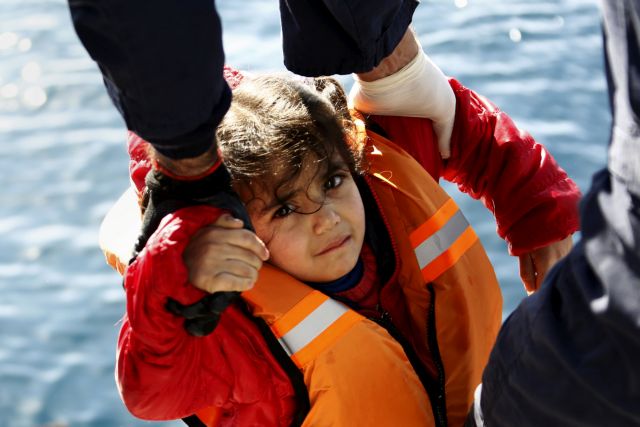 FILE PHOTO -  Greek Coast Guard officers move a girl from a dinghy carrying refugees and migrants aboard the Ayios Efstratios Coast Guard vessel,  during a rescue operation at open sea between the Turkish coast and the Greek island of Lesbos, February 8, 2016. REUTERS/Giorgos Moutafis/File Photo                     REUTERS PICTURES OF THE YEAR 2016 - SEARCH 'POY 2016' TO FIND ALL IMAGES