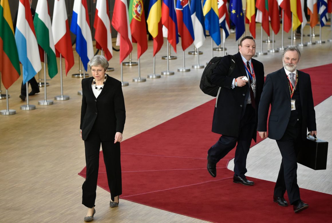 Britain's Prime minister Theresa May (L) walks towards the press as she arrives at the European Council headquarter on the second day of a summit of European Union (EU) leaders on March 23, 2018, in Brussels. European Union leaders will lay the ground on March 23 for the next phase of Brexit talks after British Prime Minister urged them to seize a "new dynamic" in the negotiations. / AFP PHOTO / JOHN THYS        (Photo credit should read JOHN THYS/AFP/Getty Images)