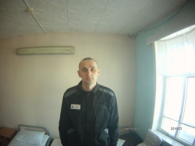 epa06940129 A handout photo taken 09 August 2018 and made available by the press center of the High Commissioner for Human Rights in the Russian Federation on 10 August 2018 shows jailed Ukrainian film director Oleg Sentsov posing for a picture at his cell in the 'White Bear' penal colony No. 8 in Labytnangi, about 20 kilometers northwest of Salekhard, in Yamalo-Nenets district, Russia. Oleg Sentsov who had been sentenced in August 2015 to 20 years in prison on charges of planning a terrorist attack in Crimea, had announced a hunger strike on 14 May 2018. EPA/Russian High Commissioner for Human Rights Press Center HANDOUT BEST QUALITY AVAILABLE HANDOUT EDITORIAL USE ONLY/NO SALES
