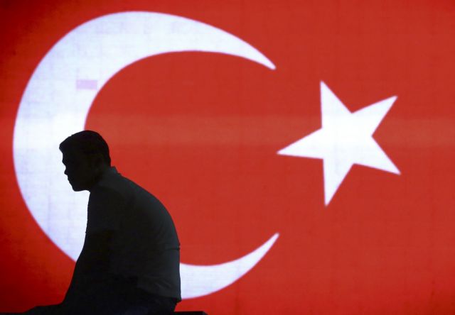 A man is silhouetted against a giant Turkish flag in Istanbul airport, Turkey, July 16, 2016.    REUTERS/Huseyin Aldemir   TPX IMAGES OF THE DAY